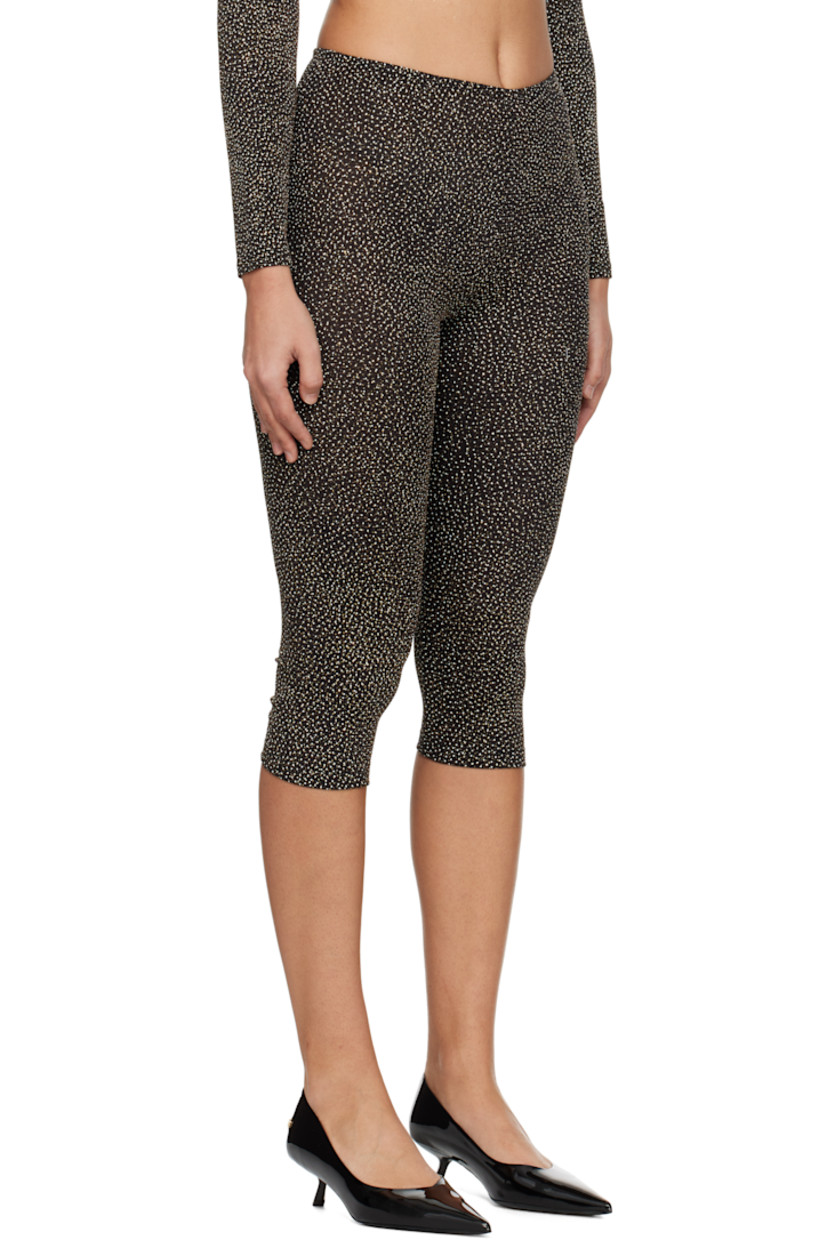 Semi-sheer plain-woven stretch nylon-blend leggings. Metallic thread detailing throughout.

· Elasticized waistband 
· Cropped leg

Supplier color: Black/Gold