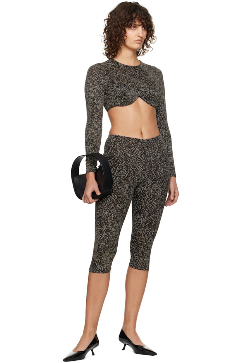 Semi-sheer plain-woven stretch nylon-blend leggings. Metallic thread detailing throughout.

· Elasticized waistband 
· Cropped leg

Supplier color: Black/Gold