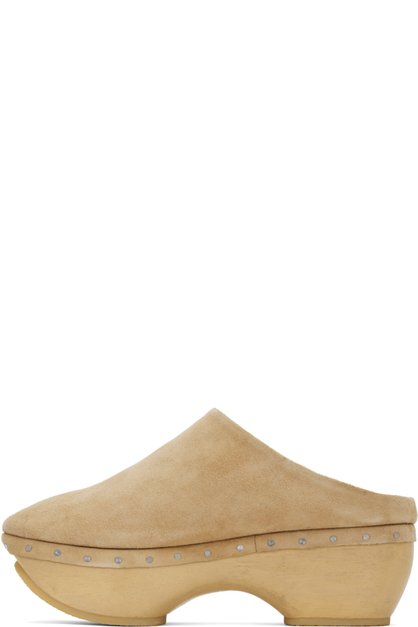 Handcrafted suede slip-on loafers in beige. 

· Logo embossed at padded footbed
· Grained leather lining
· Rivets at welt
· Hand-painted wood block heel and platform midsole
· Crepe rubber sole
· Platform: H1"
· Heel: H2.75"

Supplier color: Sand