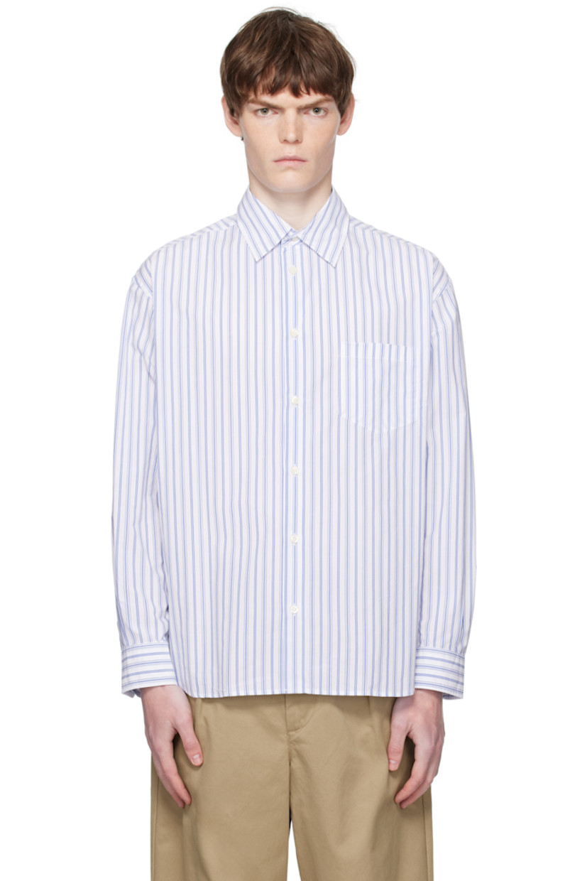 Cotton poplin shirt.

· Stripe pattern throughout
· Spread collar
· Button closure
· Patch pocket at chest
· Shirttail hem
· Buttoned barrel cuffs
· Pleats at back yoke

Supplier color: White/Blue