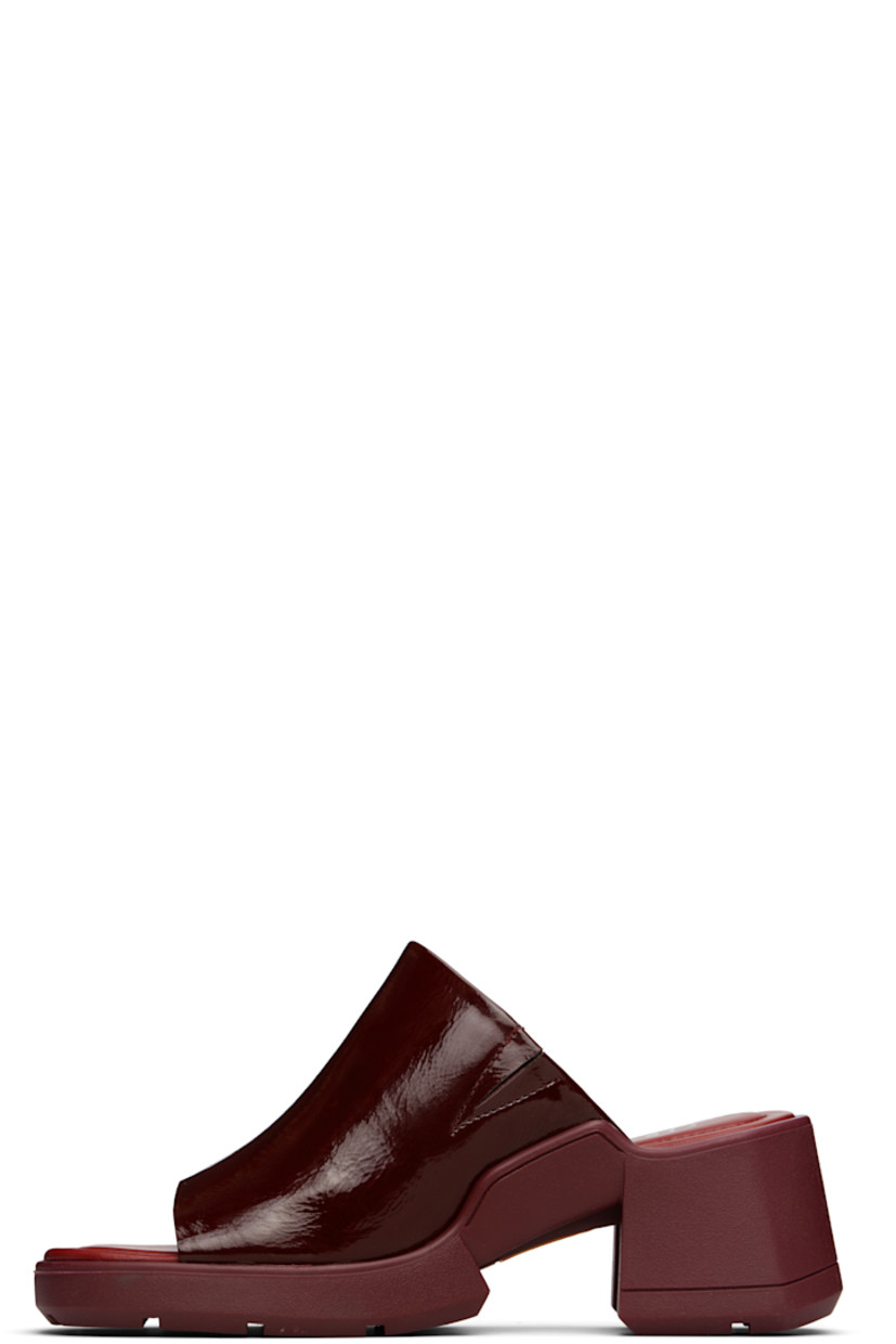 Crinkled patent leather mules.

· Open square toe 
· Concealed elasticized gusset at vamp
· Logo stamp at padded footbed
· Rubber midsole and block heel 
· Treaded rubber sole 
· Heel: H2.5"

Supplier color: Burgundy