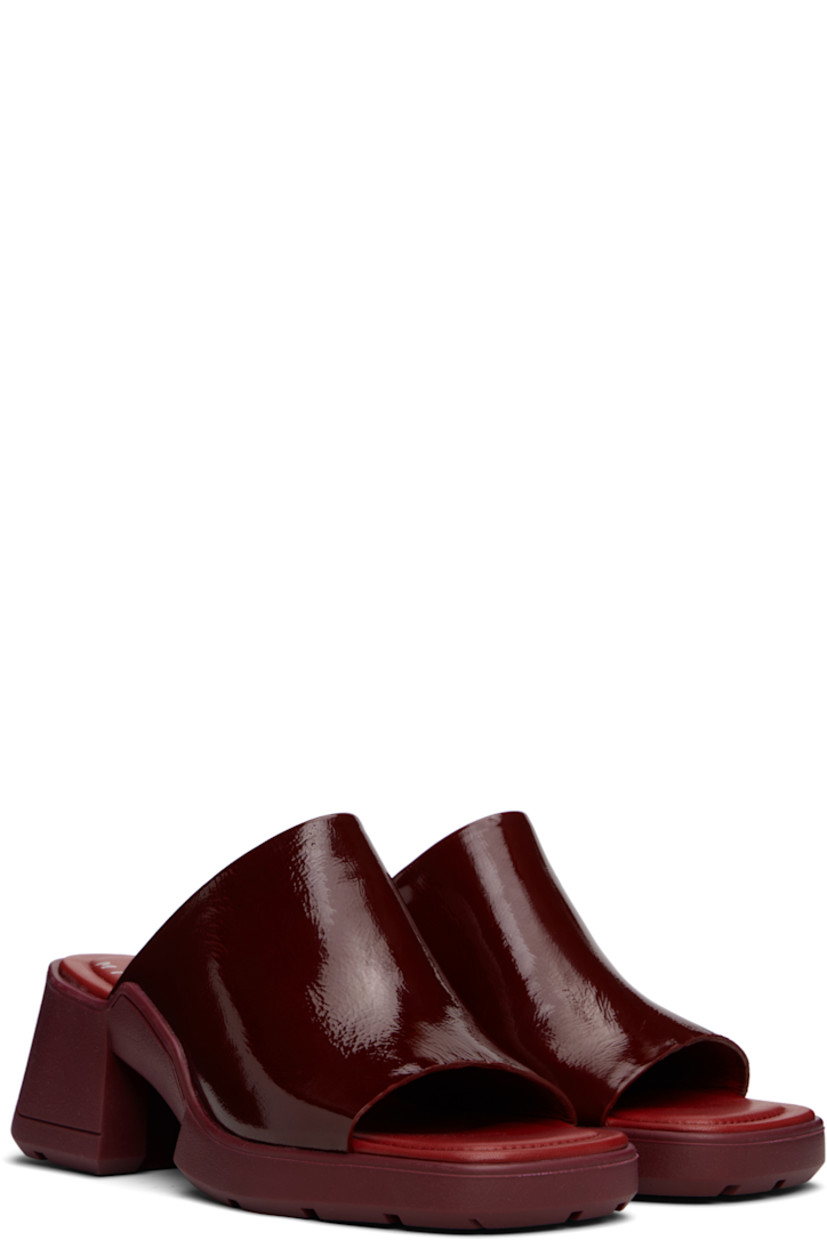 Crinkled patent leather mules.

· Open square toe 
· Concealed elasticized gusset at vamp
· Logo stamp at padded footbed
· Rubber midsole and block heel 
· Treaded rubber sole 
· Heel: H2.5"

Supplier color: Burgundy