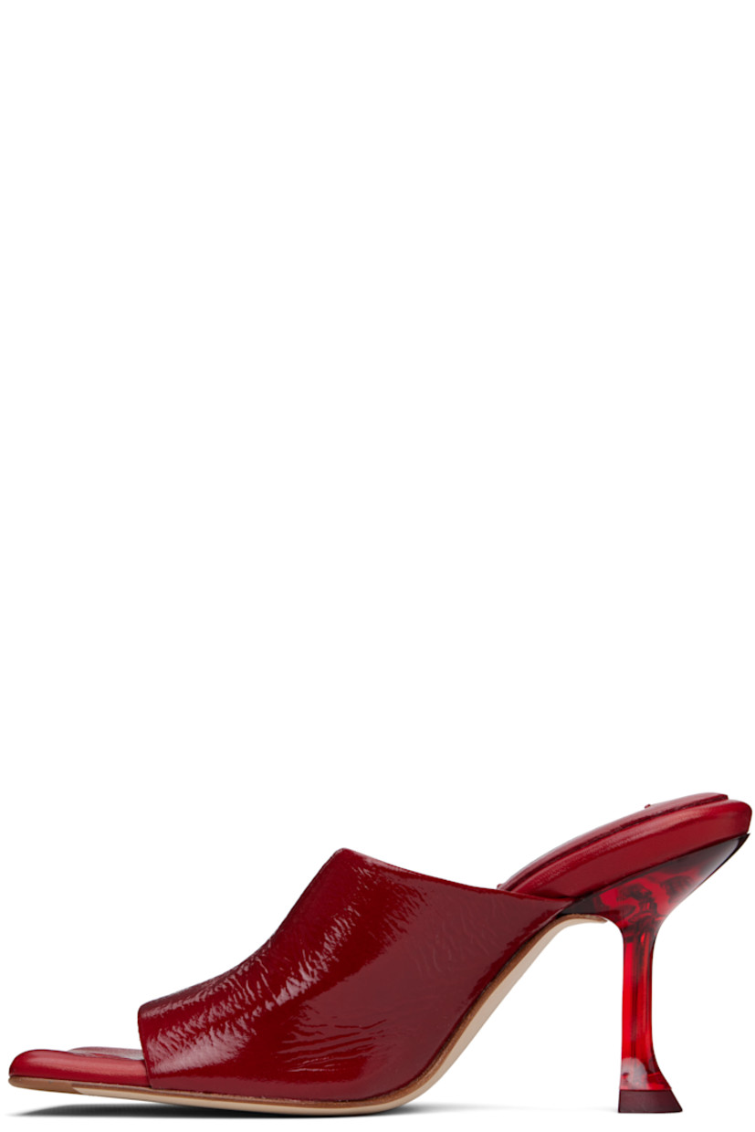 Grained goatskin mules in red.

· Open square toe
· Strap at vamp
· Padded grained leather footbed
· Semi-transparent plexiglass spool heel
· Nubuck sole with rubber injection
· Heel: H3.5"

Supplier color: Dark red