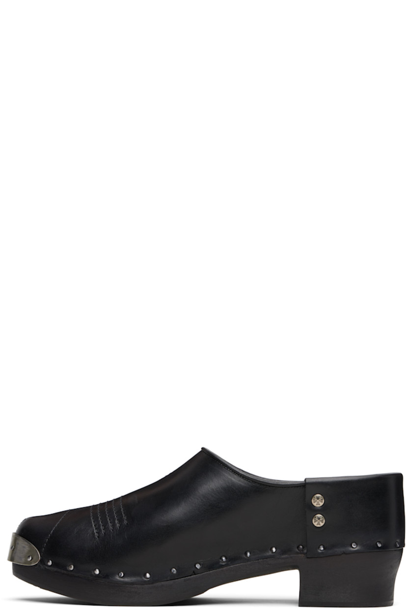 Buffed calfskin clogs.

· Studded plaque at pointed toe
· Topstitching at vamp
· Logo-engraved studs at sides
· Calfskin suede lining
· Rivets at welt
· Wood midsole and block heel
· Heel: H1.5"

Supplier color: Black
