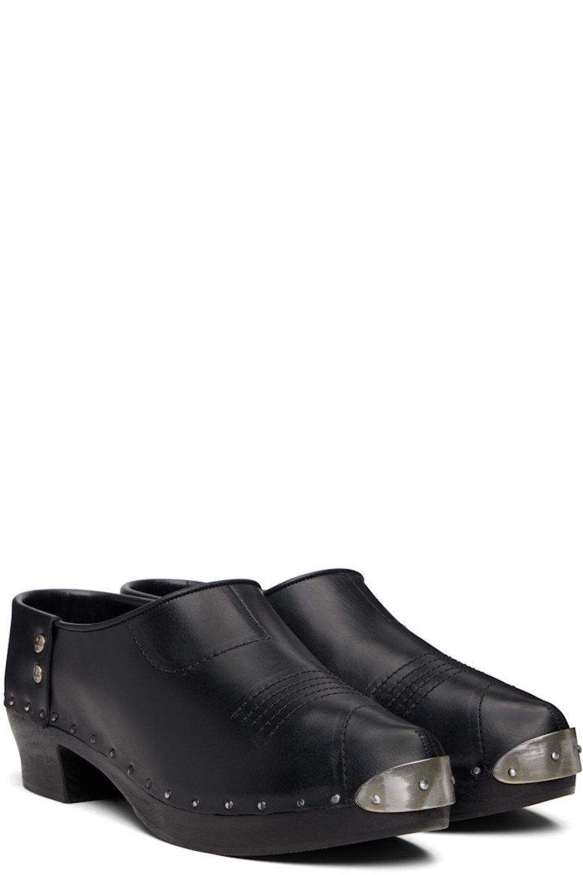 Buffed calfskin clogs.

· Studded plaque at pointed toe
· Topstitching at vamp
· Logo-engraved studs at sides
· Calfskin suede lining
· Rivets at welt
· Wood midsole and block heel
· Heel: H1.5"

Supplier color: Black