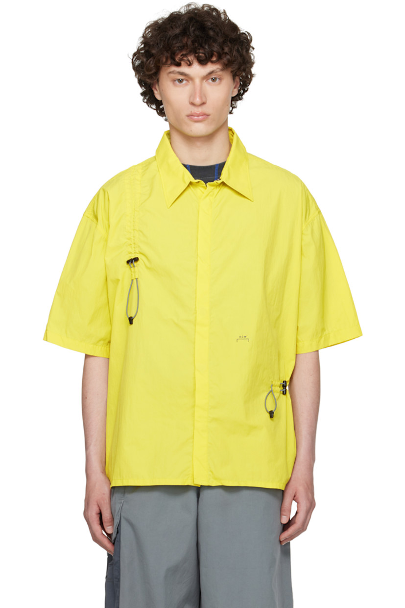 Nylon ripstop shirt.

· Spread collar
· Concealed press-stud closure
· Bungee-style drawstring extends from front to back
· Logo printed at front

Supplier color: Citronelle
