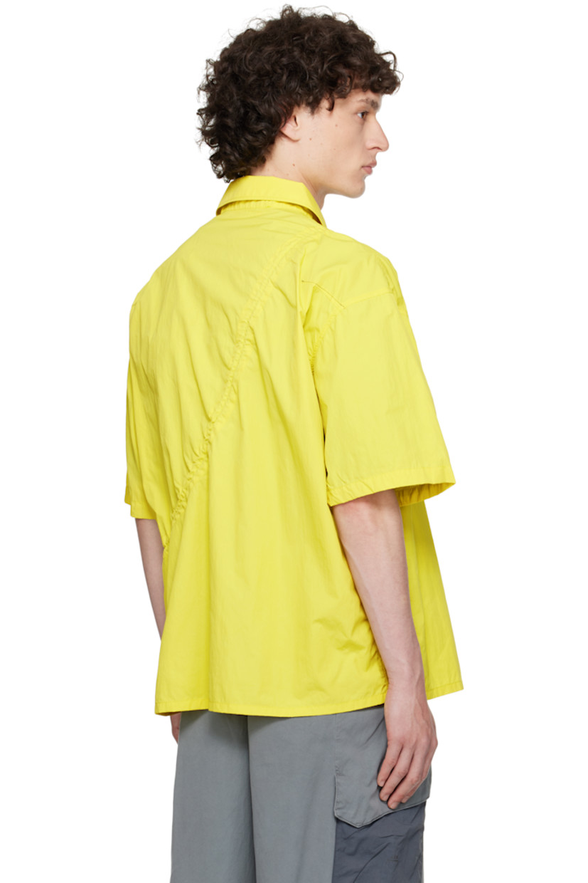 Nylon ripstop shirt.

· Spread collar
· Concealed press-stud closure
· Bungee-style drawstring extends from front to back
· Logo printed at front

Supplier color: Citronelle