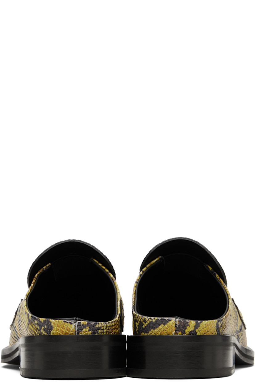Snake-embossed leather mules in yellow and black.

· Square moc toe
· Strap and curb chain at vamp
· Stacked leather heel and midsole
· Polished leather sole with rubber injections
· Silver-tone hardware
· Heel: H1.25"

Supplier color: Yellow/Black
