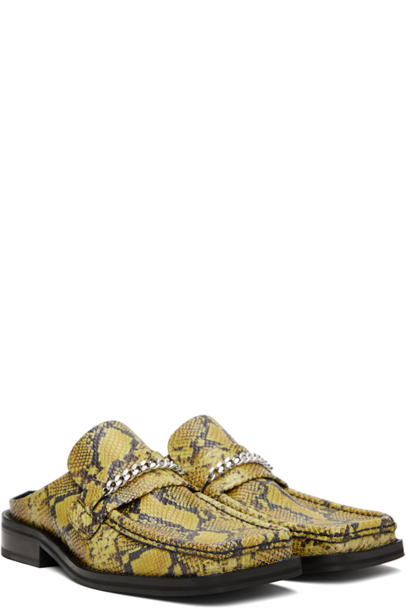 Snake-embossed leather mules in yellow and black.

· Square moc toe
· Strap and curb chain at vamp
· Stacked leather heel and midsole
· Polished leather sole with rubber injections
· Silver-tone hardware
· Heel: H1.25"

Supplier color: Yellow/Black