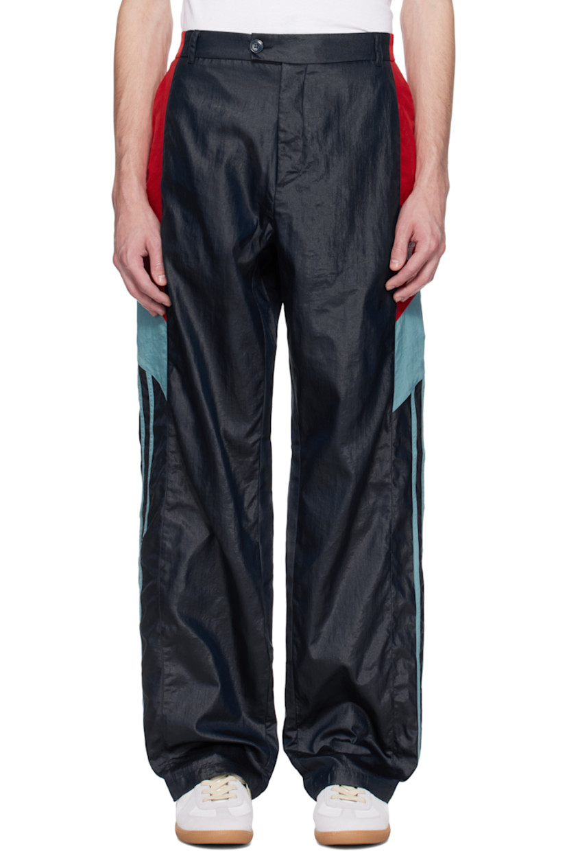 Nylon taffeta track pants. 

· Paneled construction
· Belt loops at partially elasticized waistband
· Three-pocket styling
· Zip fly
· Logo embroidered at leg
· Striped trim at outseams 

Supplier color: Blue
