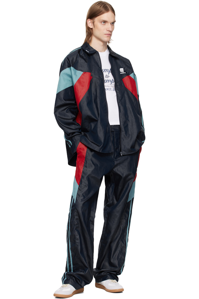 Nylon taffeta track pants. 

· Paneled construction
· Belt loops at partially elasticized waistband
· Three-pocket styling
· Zip fly
· Logo embroidered at leg
· Striped trim at outseams 

Supplier color: Blue