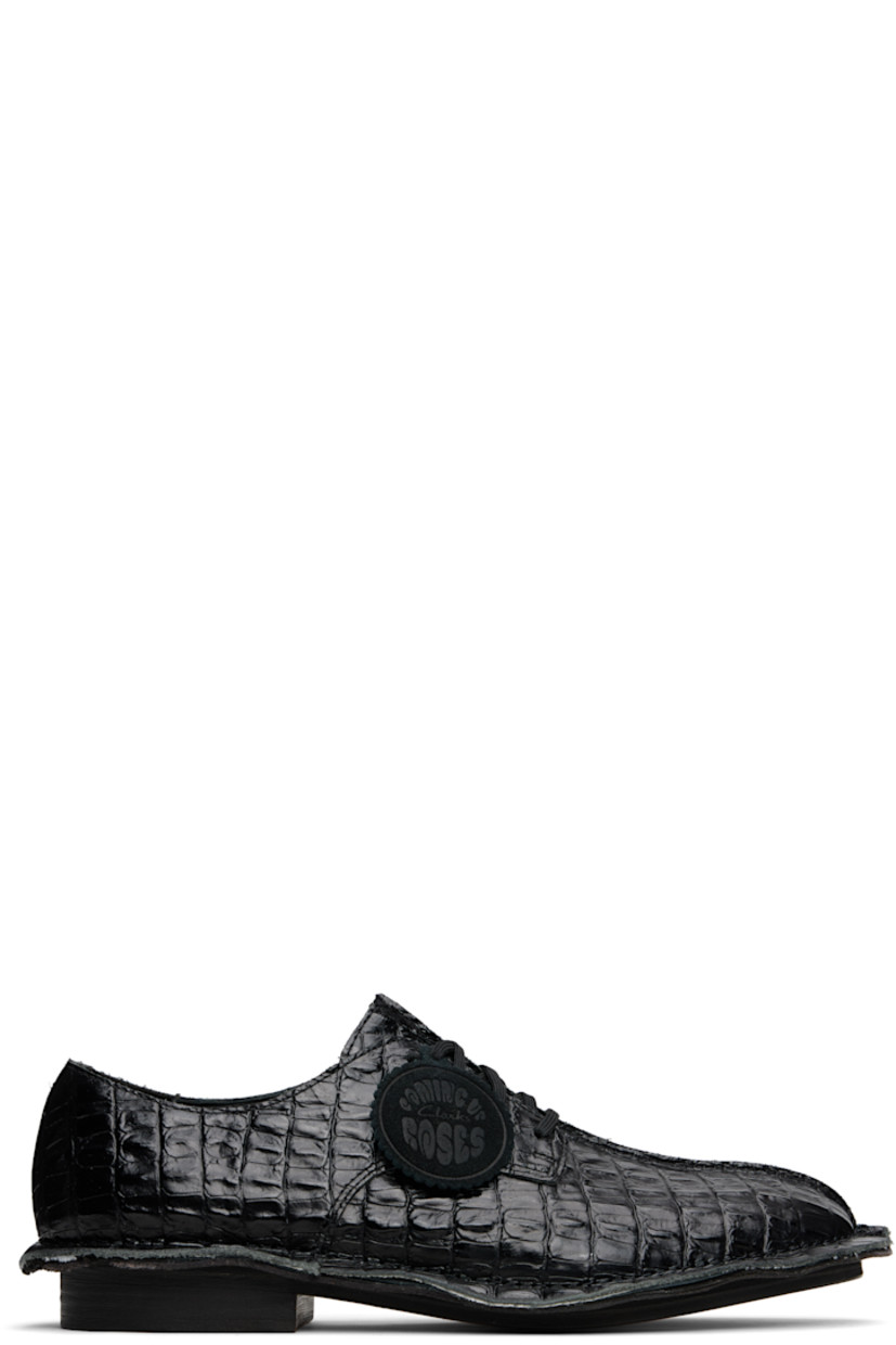 Croc-embossed leather derbys.

· Square toe
· Pinched seam at vamp and welt
· Logo tag at lace-up closure
· Buffed leather lining
· Stacked leather heel
· Leather sole

Part of the Martine Rose x Clarks collaboration.

Supplier color: Black