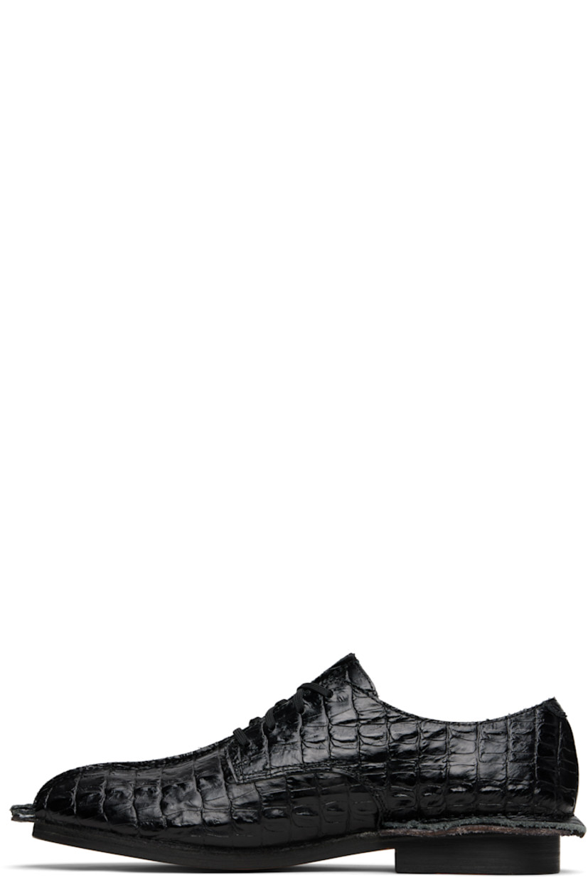 Croc-embossed leather derbys.

· Square toe
· Pinched seam at vamp and welt
· Logo tag at lace-up closure
· Buffed leather lining
· Stacked leather heel
· Leather sole

Part of the Martine Rose x Clarks collaboration.

Supplier color: Black