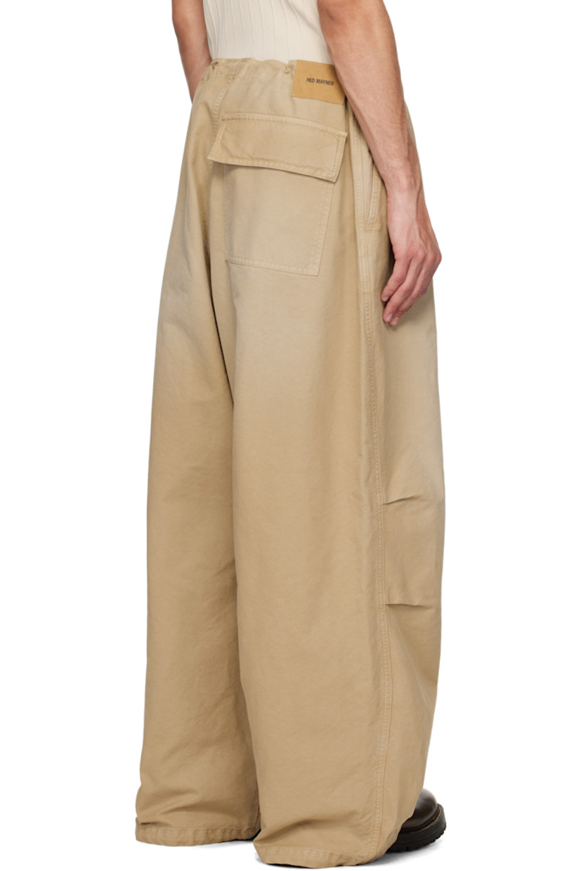 Cotton canvas trousers. Fading throughout.

· Concealed drawstring at waistband and cuffs
· Three-pocket styling
· Zip fly
· Logo flag at front pocket
· Pleats at knees
· Logo patch at back waistband

Supplier color: Beige/Khaki