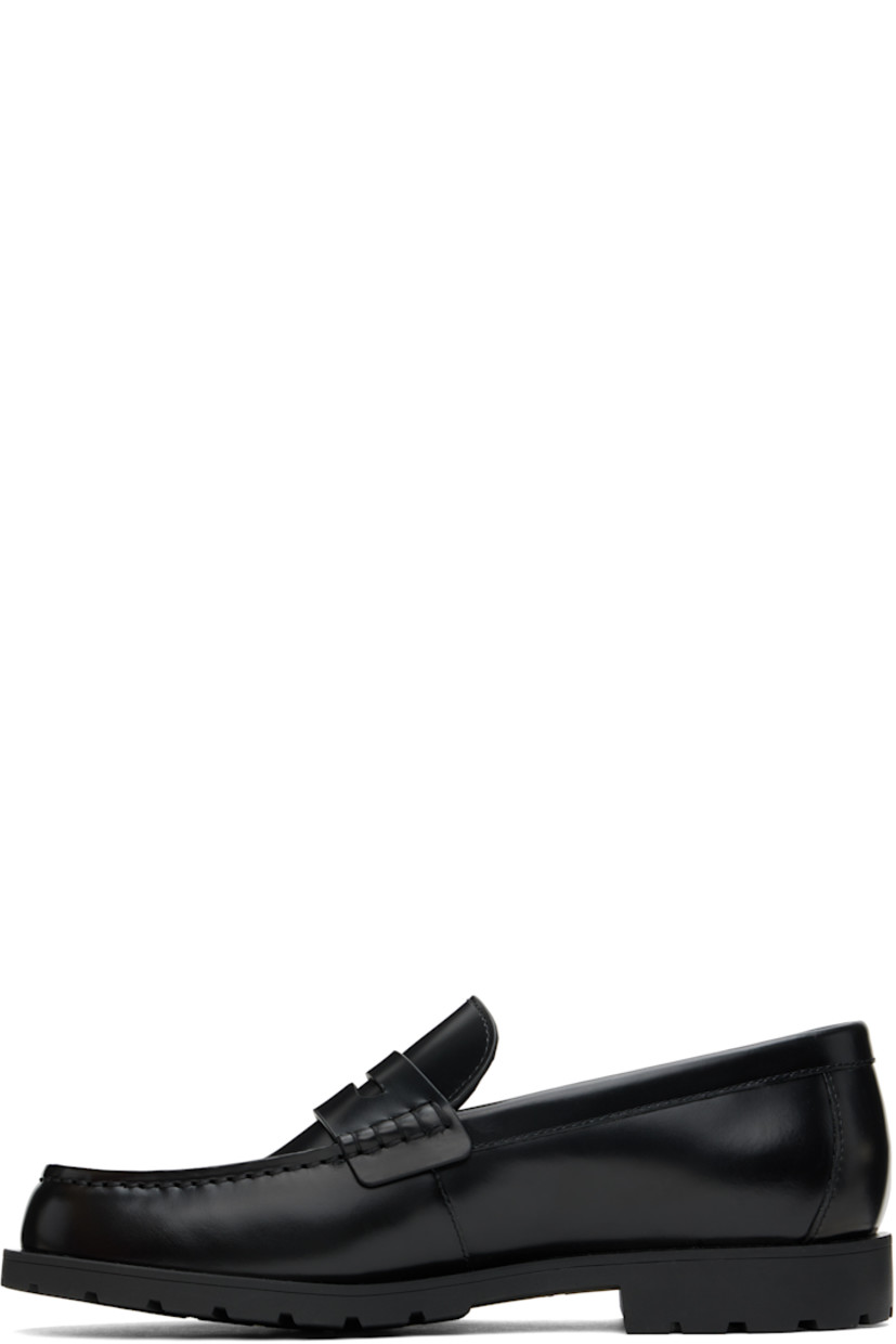 Polished leather loafers in black.

· Moc toe
· Strap with cutout at vamp
· Logo flag at outer side
· Treaded rubber sole

Supplier color: Black