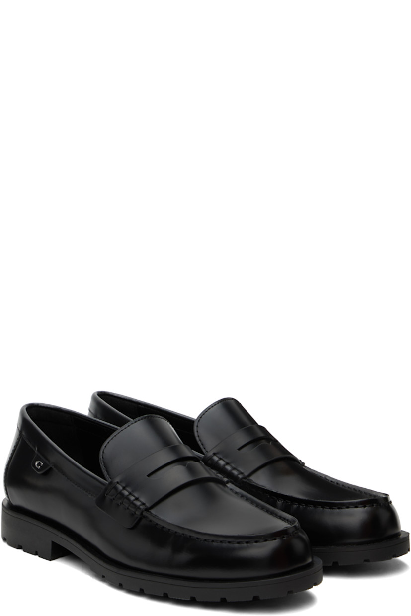 Polished leather loafers in black.

· Moc toe
· Strap with cutout at vamp
· Logo flag at outer side
· Treaded rubber sole

Supplier color: Black