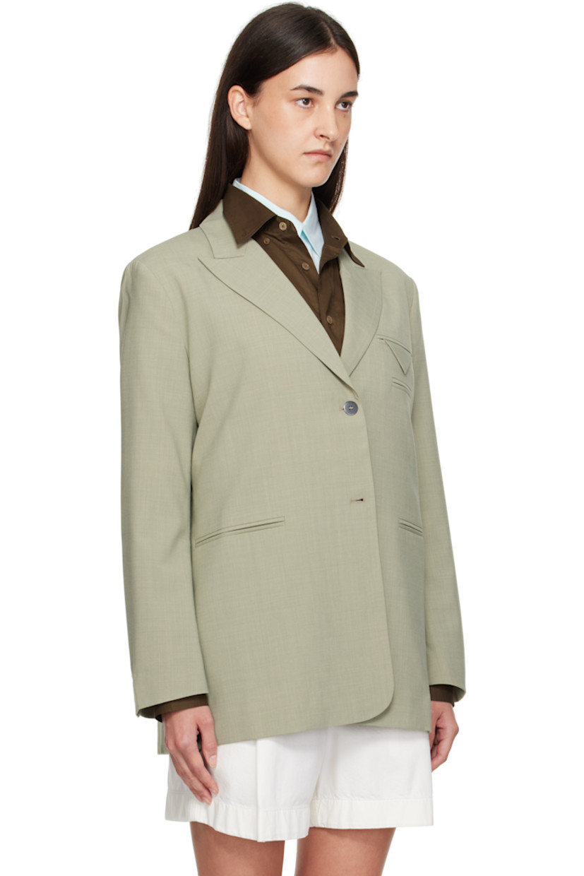 Woven stretch virgin wool-blend blazer.

· Peaked lapel
· Two-button closure
· Welt pockets at chest and waist
· Buttoned surgeon's cuffs
· Vented back hem
· Full satin lining
· Black metal hardware

Supplier color: Salvia