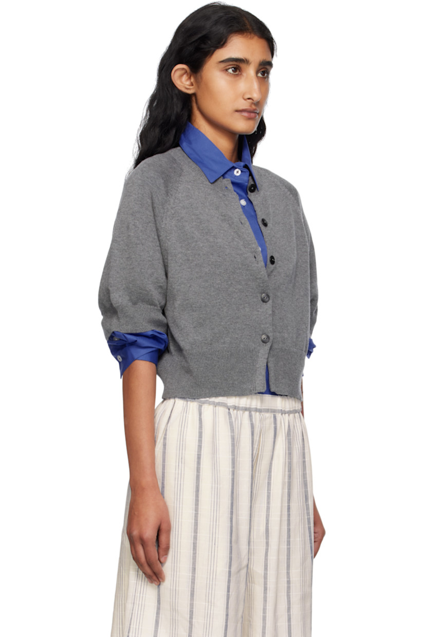Knit organic cotton- and cashmere-blend cardigan. 

· OEKO-TEX® Standard 100-, ZDHC-, and BCI-certified
· Rib-knit crewneck, hem, and cuffs
· Button closure
· Cropped hem
· Raglan sleeves
· Logo-engraved hardware

Supplier color: Grey