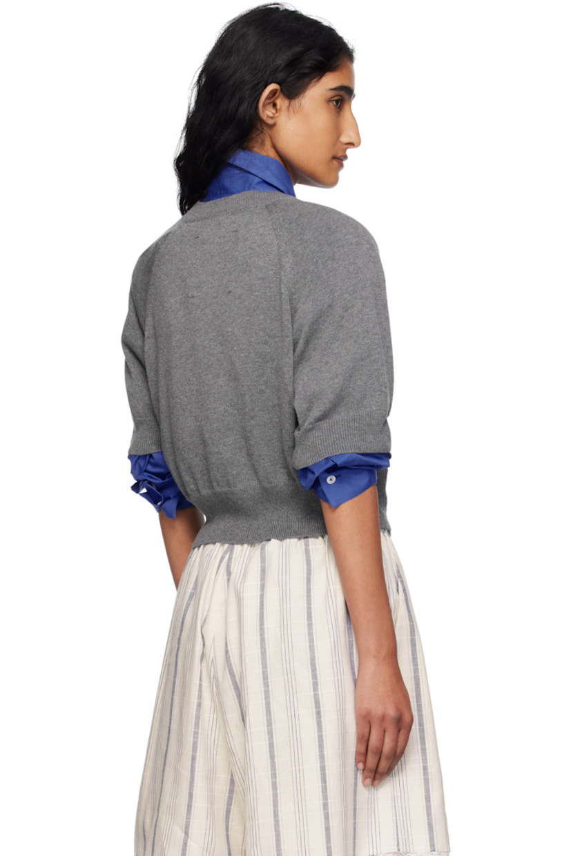 Knit organic cotton- and cashmere-blend cardigan. 

· OEKO-TEX® Standard 100-, ZDHC-, and BCI-certified
· Rib-knit crewneck, hem, and cuffs
· Button closure
· Cropped hem
· Raglan sleeves
· Logo-engraved hardware

Supplier color: Grey