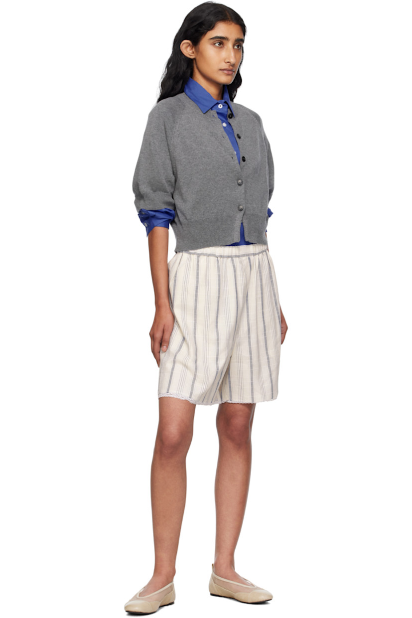 Knit organic cotton- and cashmere-blend cardigan. 

· OEKO-TEX® Standard 100-, ZDHC-, and BCI-certified
· Rib-knit crewneck, hem, and cuffs
· Button closure
· Cropped hem
· Raglan sleeves
· Logo-engraved hardware

Supplier color: Grey