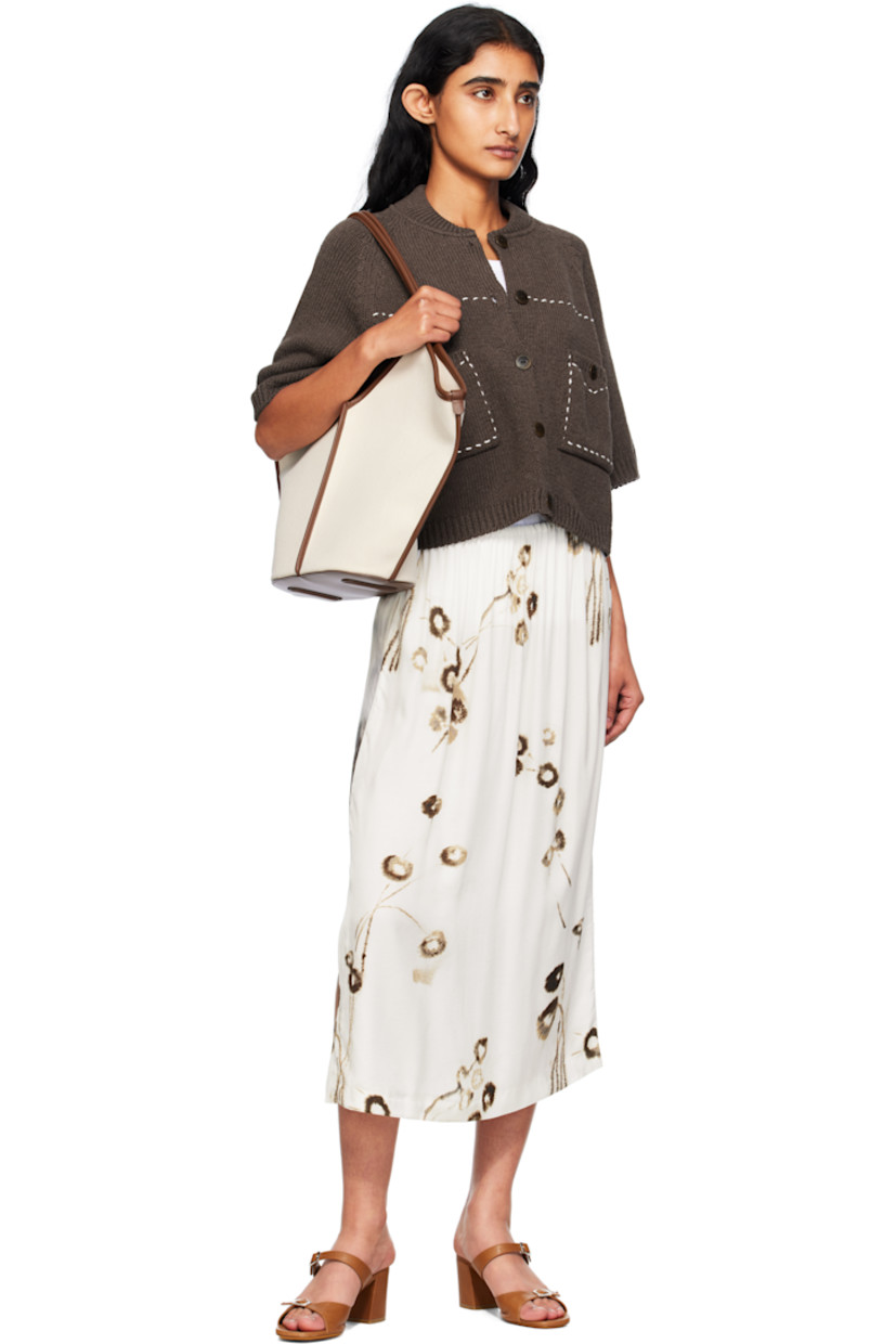 Knit ECOTEC® upcycled cotton-blend cardigan. 

· Certified GOTS and OEKO-TEX® Standard 100
· Rib-knit stand collar, hem, and cuffs
· Button closure
· Topstitching in white at front
· Patch pockets at waist
· Raglan sleeves
· Logo-engraved hardware

Supplier color: Brown