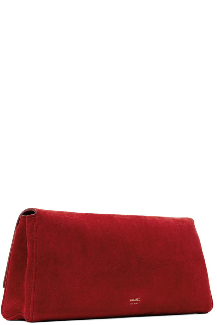 Calfskin suede clutch in red.

· Logo stamp at back face
· Graphic hardware at magnetic flap 
· Card slot at interior
· Grained leather lining
· Logo-engraved antiqued gold-tone hardware
· H5.5" x W12" x D2.5"

Supplier color: Rebel suede