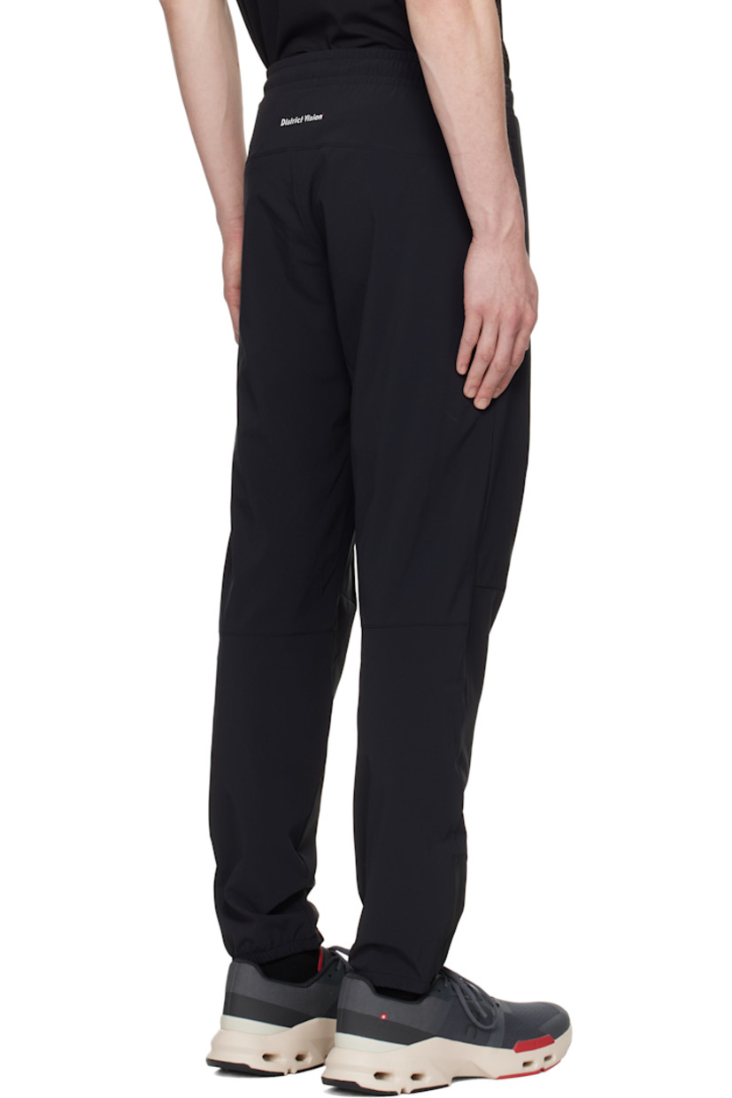 Lightweight 135 gsm stretch nylon taffeta track pants.

· Water-resistant, non-PFC DWR coating
· Drawstring at elasticized waistband
· Two-pocket styling
· Logo printed at front
· Darts at knees
· Zip vent at elasticized cuffs
· Logo bonded at back waist

Supplier color: Black