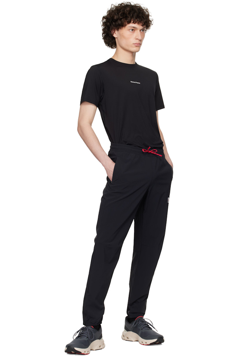 Lightweight 135 gsm stretch nylon taffeta track pants.

· Water-resistant, non-PFC DWR coating
· Drawstring at elasticized waistband
· Two-pocket styling
· Logo printed at front
· Darts at knees
· Zip vent at elasticized cuffs
· Logo bonded at back waist

Supplier color: Black
