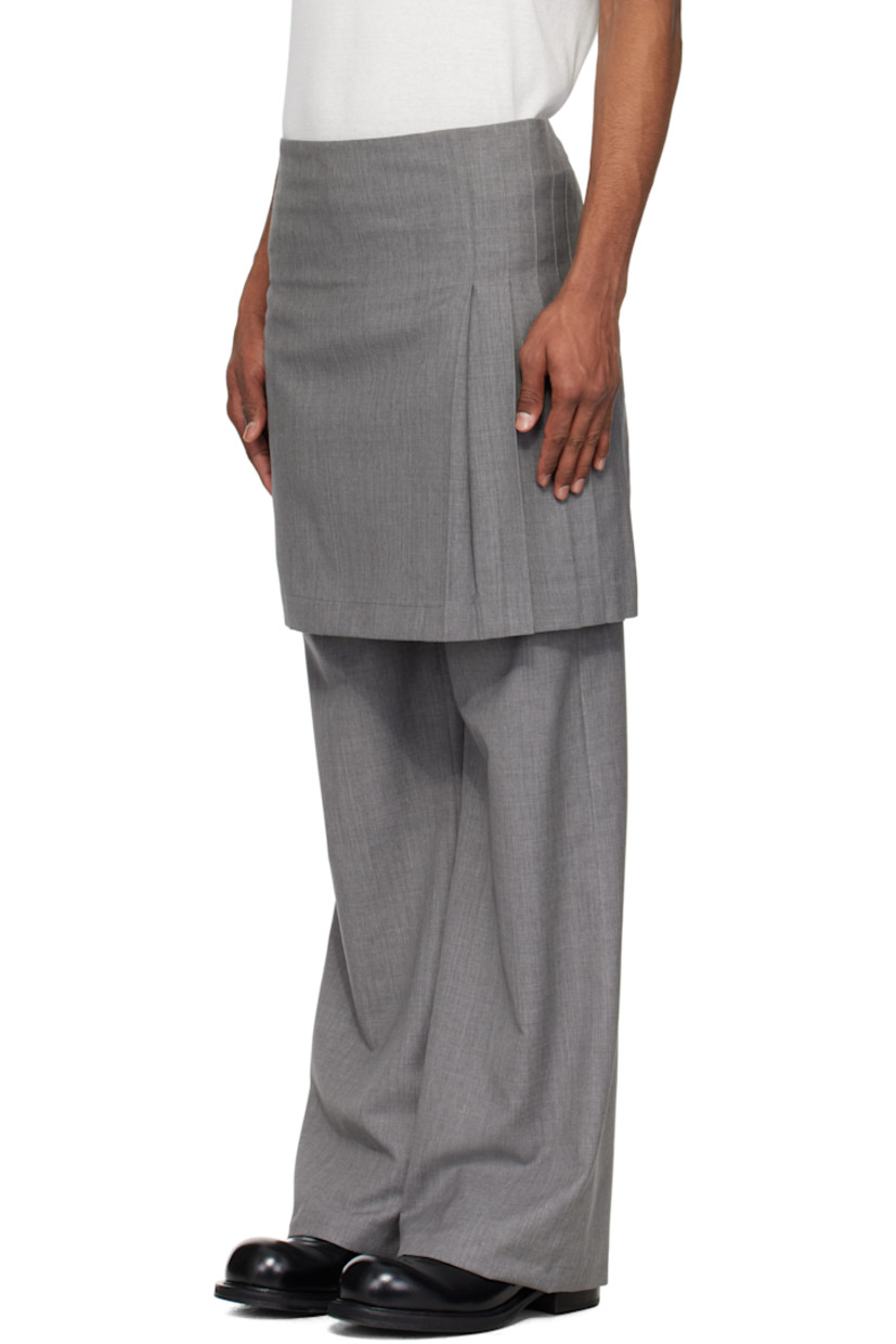 Virgin wool delaine trousers.

· Layered construction
· Pleated kilt-style overlay at waist
· Concealed zip fly
· Pin-buckle straps at outseam

Supplier color: Grey