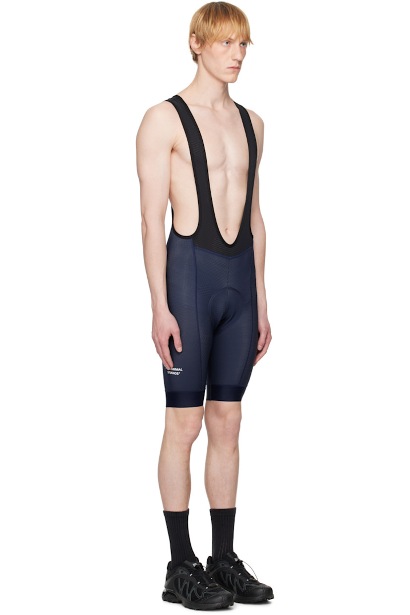 Lightweight textured stretch nylon jersey and stretch polyester mesh bibs-style shorts.

· Moisture-wicking 
· Paneled construction
· Gusset at inseam
· Bonded logo at outseams
· Logo flag at outseam
· Bonded text at back 
· Elasticized suspender-style shoulder straps
· Padded foam chamois panel at interior inseams
· Anti-slip trim at interior cuffs

Supplier color: Navy