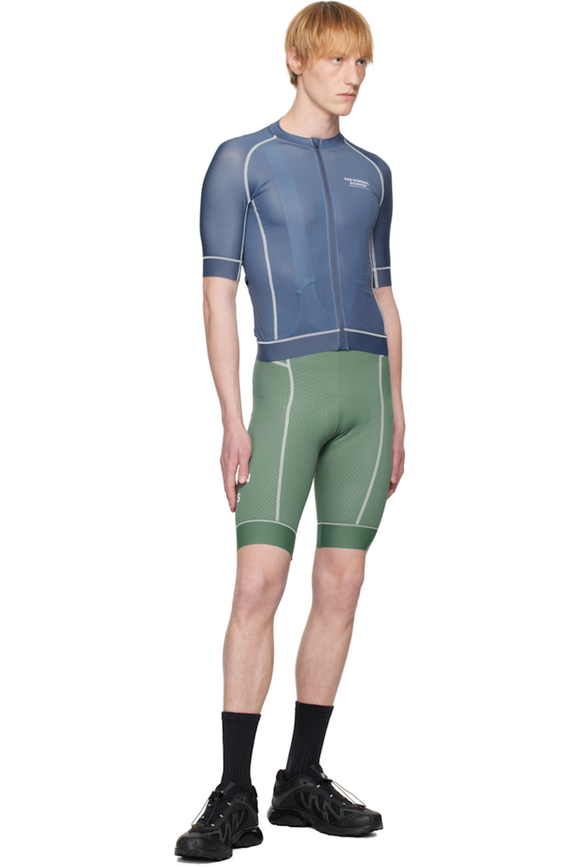 Lightweight stretch polyester jersey and mesh T-shirt. Overlock stitching throughout. 

· Paneled construction
· Band collar
· Zip closure
· Logo printed at chest and back
· Anti-slip silicone trim at elasticized hem and cuffs
· Zip seam pocket
· Logo flag at side seam
· Raglan sleeves
· Patch pockets at back

Supplier color: Light indigo