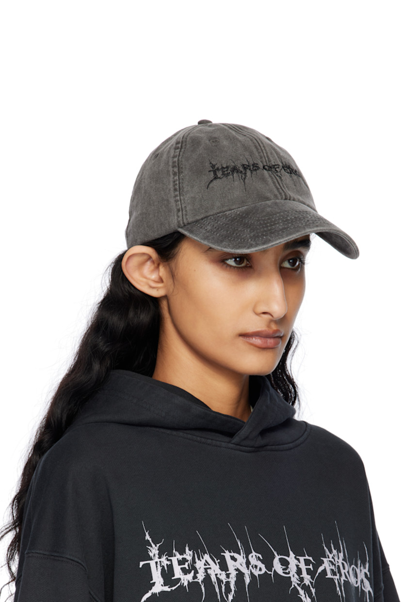 Cotton twill cap in black.

· Fading and subtle distressing throughout
· Embroidered eyelets at crown
· Text embroidered at face
· Curved brim
· Cinch fastening

Supplier color: Washed black