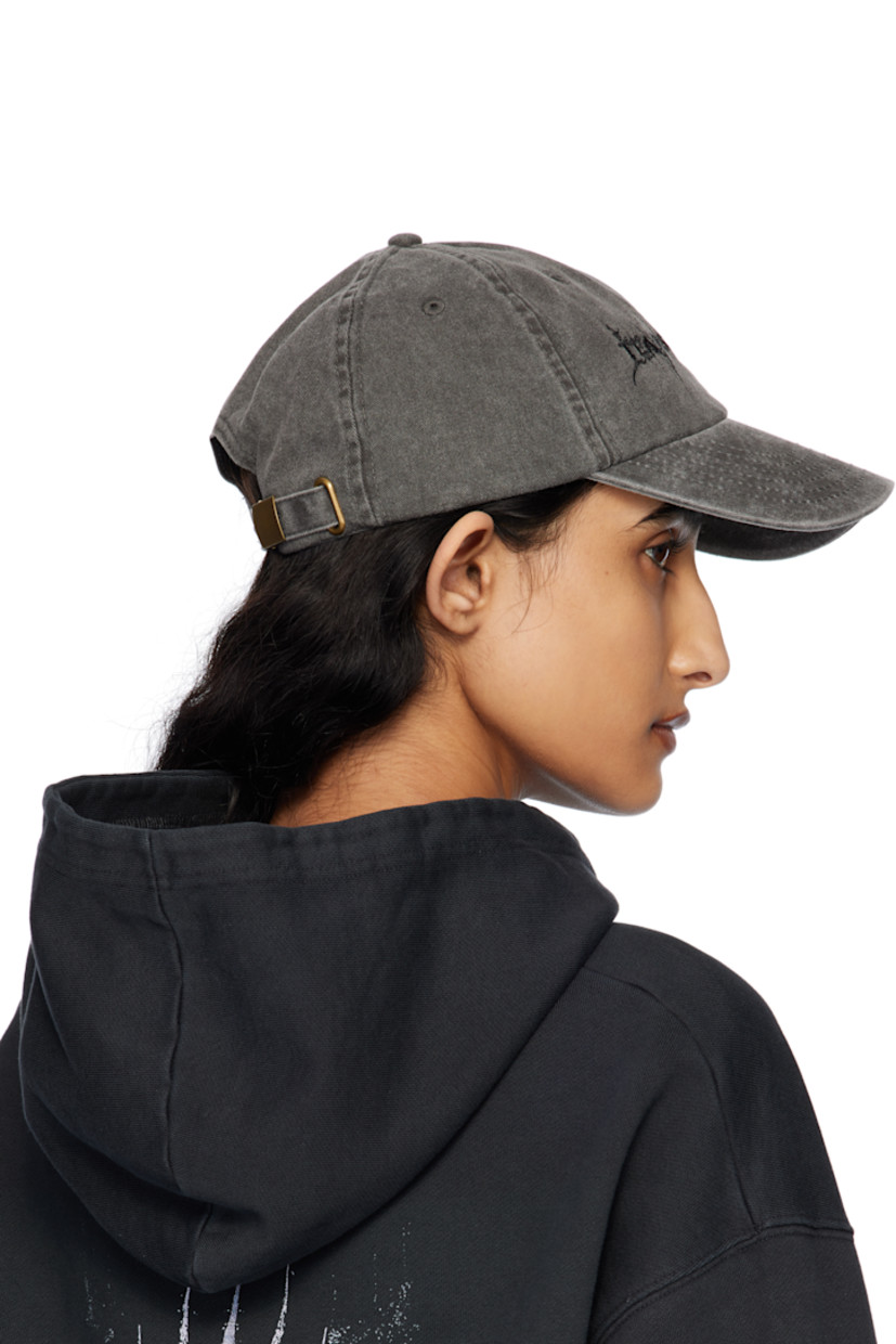Cotton twill cap in black.

· Fading and subtle distressing throughout
· Embroidered eyelets at crown
· Text embroidered at face
· Curved brim
· Cinch fastening

Supplier color: Washed black