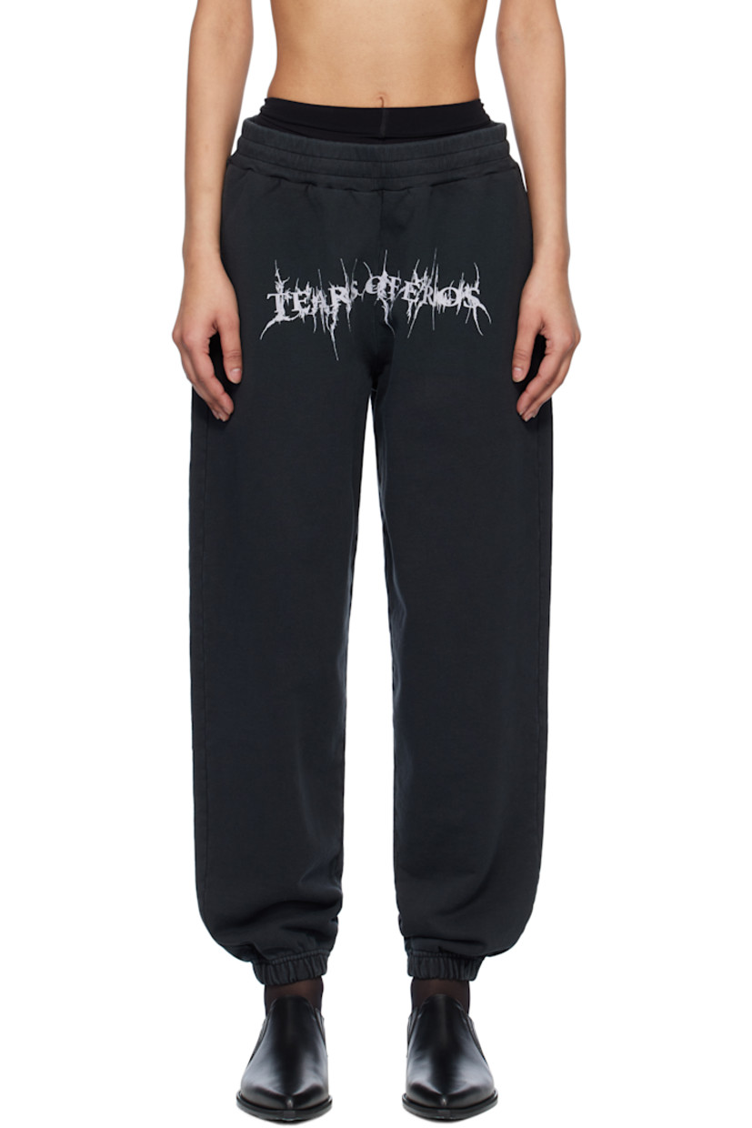 Oversized organic cotton French terry sweatpants. Fading throughout.

· Pre-shrunk
· Concealed drawstring at elasticized waistband
· Three-pocket styling
· Text printed at front
· Elasticized cuffs

Supplier color: Washed black