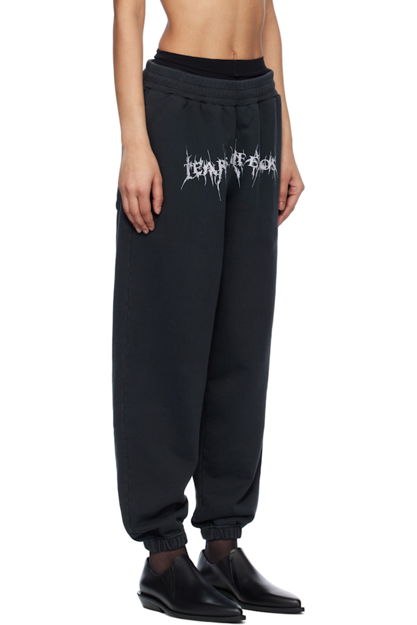 Oversized organic cotton French terry sweatpants. Fading throughout.

· Pre-shrunk
· Concealed drawstring at elasticized waistband
· Three-pocket styling
· Text printed at front
· Elasticized cuffs

Supplier color: Washed black