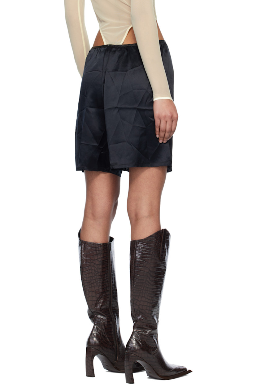 Silk satin shorts. 

· Elasticized faux-leather waistband
· Mock fly
· Raw edge at cuffs

Supplier color: Black