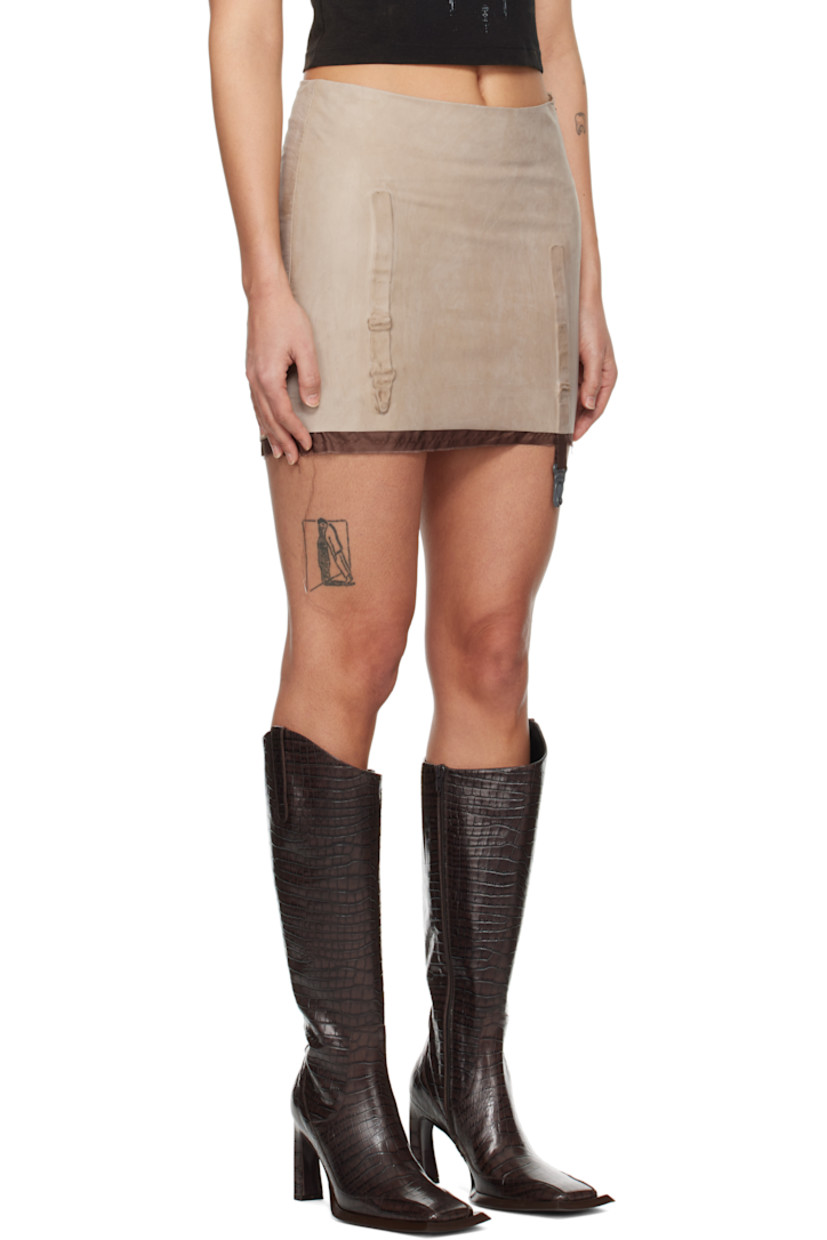 Grained leather miniskirt. Fading throughout.

· Molded garter straps at front and back
· Raw edge at hem
· Zip closure at side seam
· Full silk satin lining

Supplier color: Nude