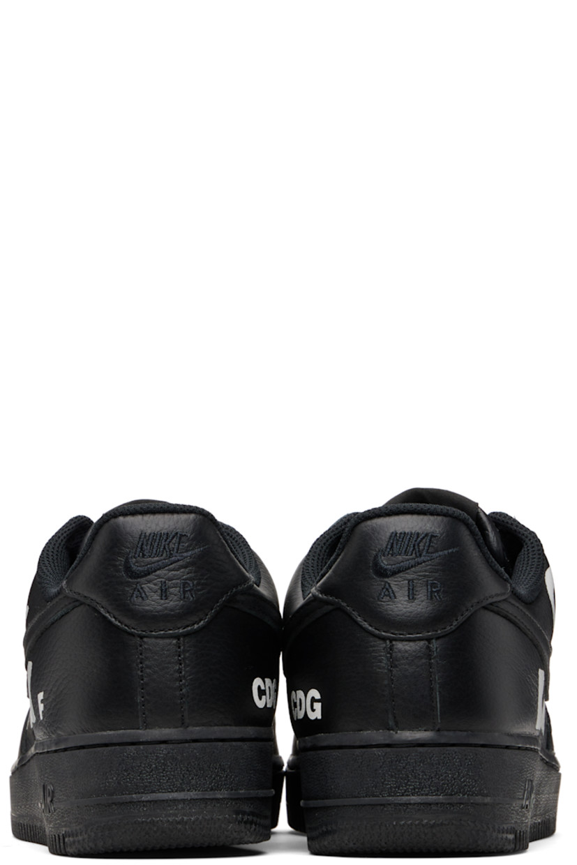 Low-top grained leather sneakers.

· Perforations at toe and sides
· Logo plaque at lace-up closure
· Padded tongue and collar
· Swoosh appliqué at sides
· Text printed at outer side
· Logo printed at inner side
· Logo embroidered at heel tab
· Mesh lining
· Treaded rubber sole

Part of the Comme des Garçons Black x Nike collaboration. 

Supplier color: Black/White
