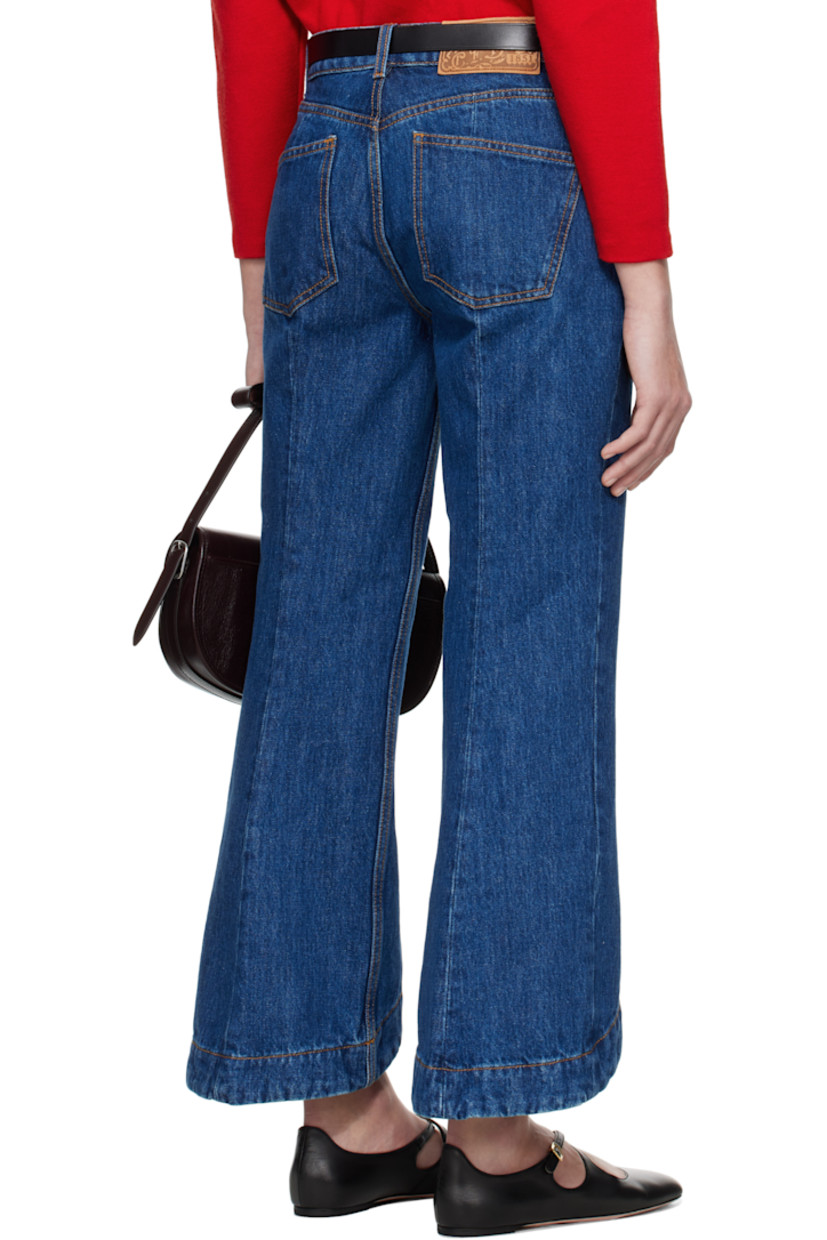 Flared non-stretch denim jeans. 

· Belt loops
· Five-pocket styling
· Zip fly
· Pinched seams at front 
· Slanted cuffs
· Cropped legs
· Logo patch at back waistband
· Contrast stitching in tan

Supplier color: Blue