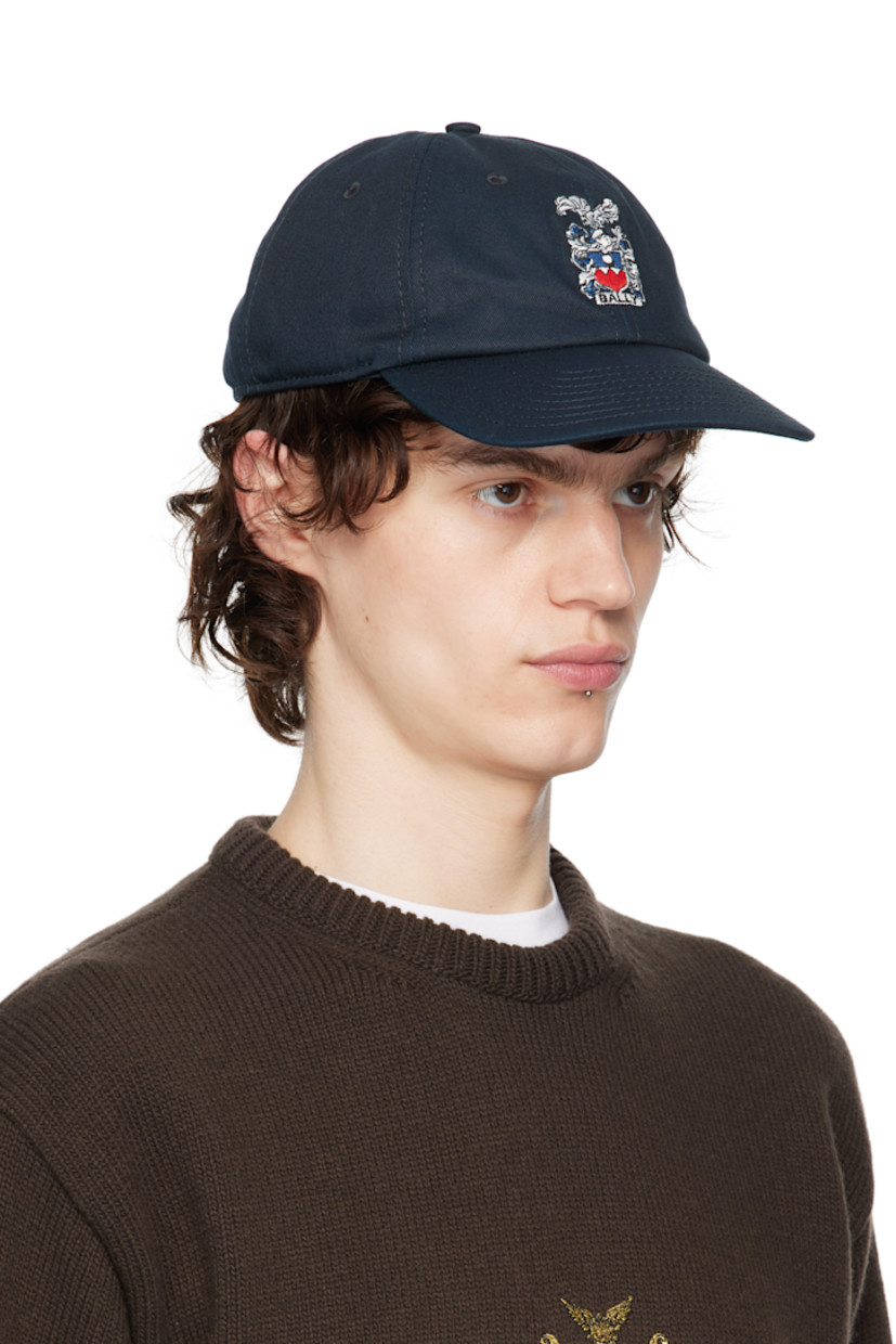 Cotton twill cap in navy. 

· Embroidered eyelets at crown
· Logo graphic embroidered at face
· Curved brim 
· Logo embroidered at back
· Cinch fastening
· Twill browband
· Partial twill lining 

Supplier color: Blue