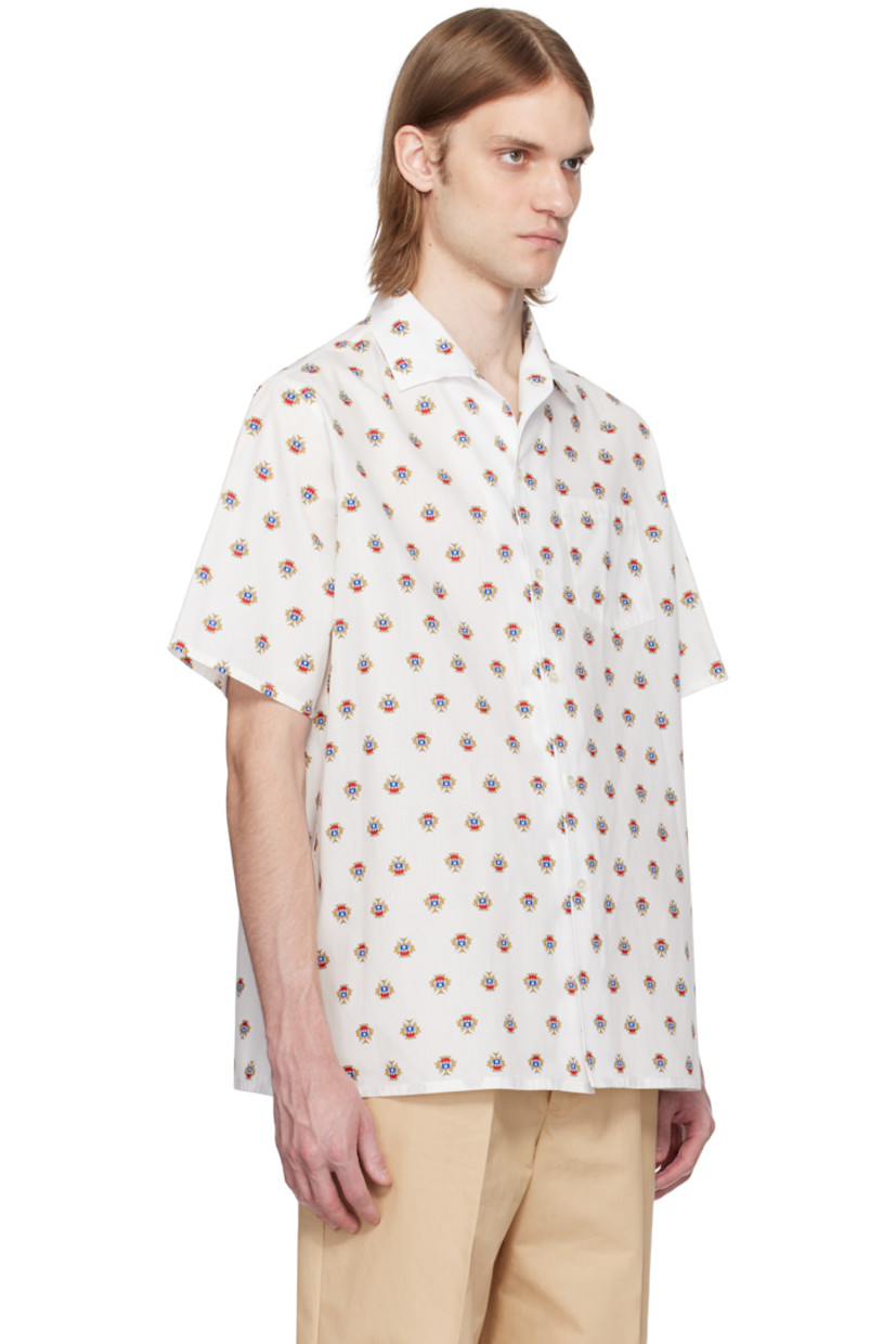 Cotton poplin shirt. Graphic pattern printed throughout.

· Open spread collar
· Button closure
· Patch pocket
· Vent at side seams
· Logo flag at cuff

Supplier color: Multibone