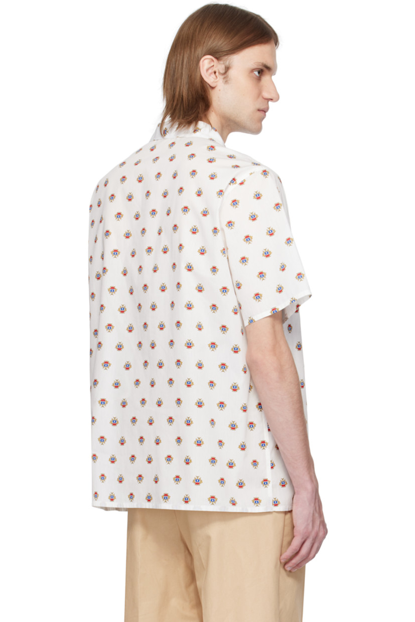 Cotton poplin shirt. Graphic pattern printed throughout.

· Open spread collar
· Button closure
· Patch pocket
· Vent at side seams
· Logo flag at cuff

Supplier color: Multibone