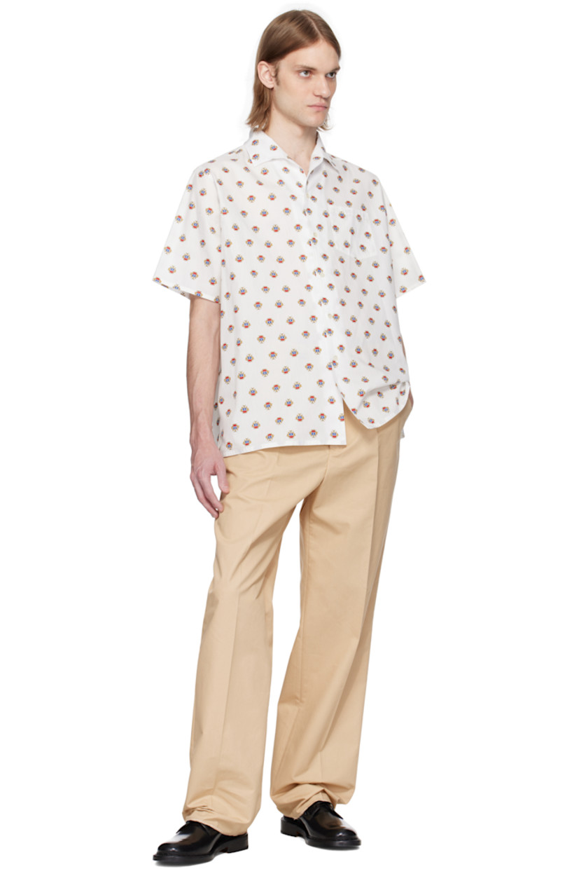 Cotton poplin shirt. Graphic pattern printed throughout.

· Open spread collar
· Button closure
· Patch pocket
· Vent at side seams
· Logo flag at cuff

Supplier color: Multibone