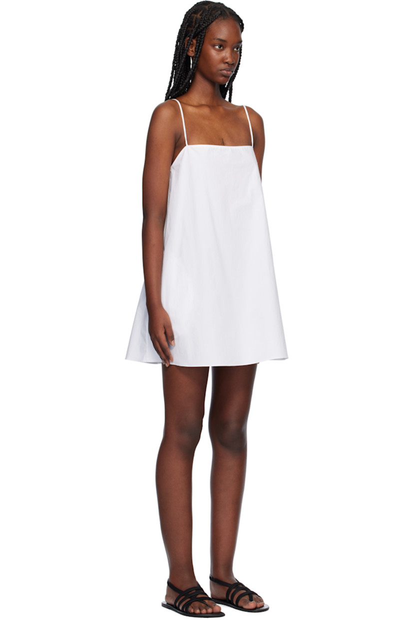 Organic cotton poplin minidress. 

· Square neck
· Seam pockets
· Fixed spaghetti straps
· Unlined

Supplier color: White