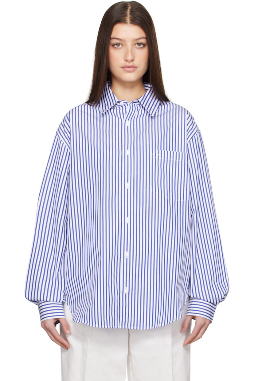 Organic cotton poplin shirt. Stripes throughout. 

· Spread collar
· Button closure
· Patch pocket at chest
· Shirttail hem
· Dropped shoulders
· Pleats at single-button barrel cuffs
· Box pleat at back yoke

Supplier color: Cobalt stripe