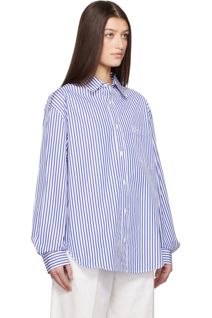 Organic cotton poplin shirt. Stripes throughout. 

· Spread collar
· Button closure
· Patch pocket at chest
· Shirttail hem
· Dropped shoulders
· Pleats at single-button barrel cuffs
· Box pleat at back yoke

Supplier color: Cobalt stripe