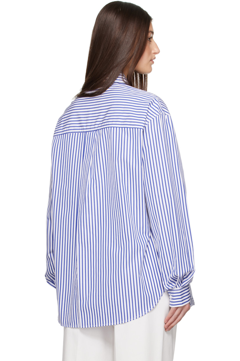 Organic cotton poplin shirt. Stripes throughout. 

· Spread collar
· Button closure
· Patch pocket at chest
· Shirttail hem
· Dropped shoulders
· Pleats at single-button barrel cuffs
· Box pleat at back yoke

Supplier color: Cobalt stripe