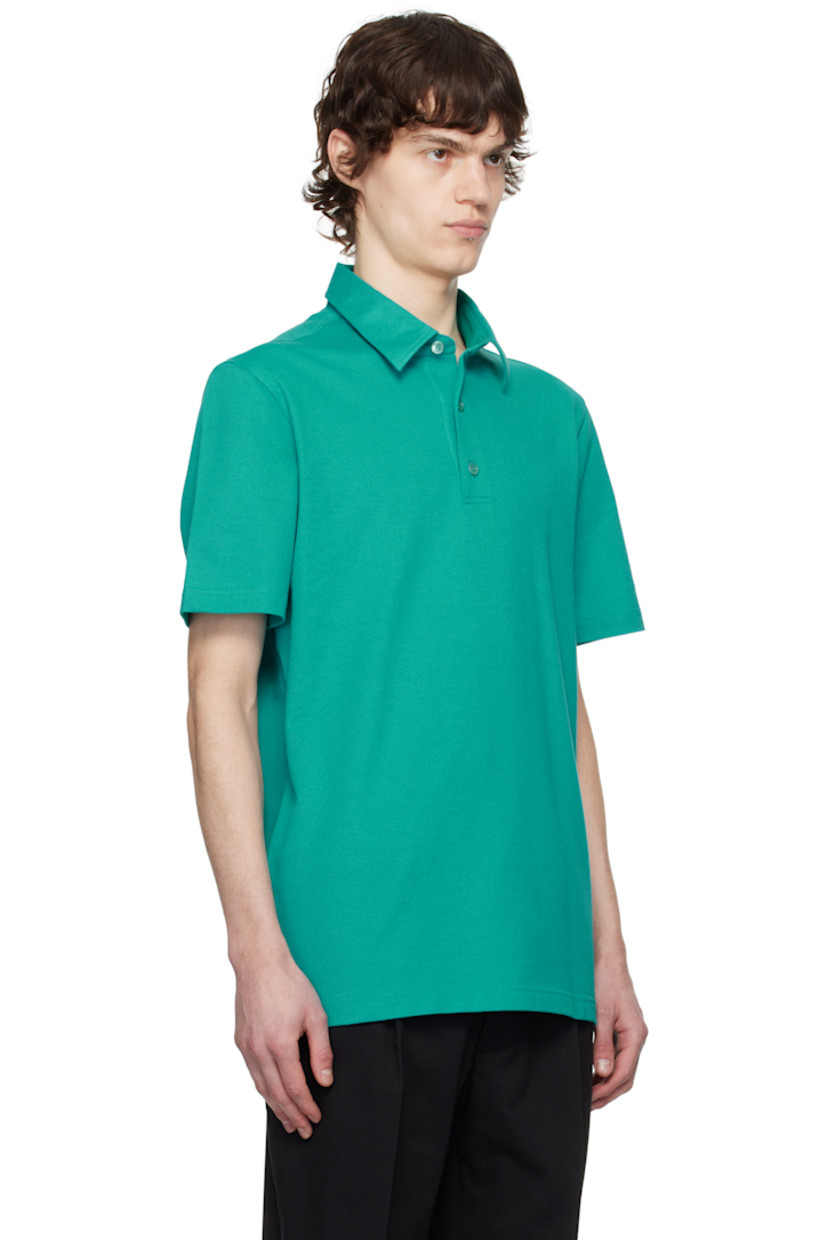 Cotton piqué polo.

· Spread collar
· Three-button placket
· Logo patch at tennis-tail hem

Supplier color: Emerald/Aqua