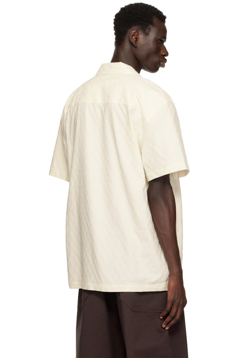 Organic cotton twill shirt. Jacquard pattern woven throughout.

· Open spread collar
· Button closure
· Embroidered logo graphic at patch pocket

Supplier color: Off-White