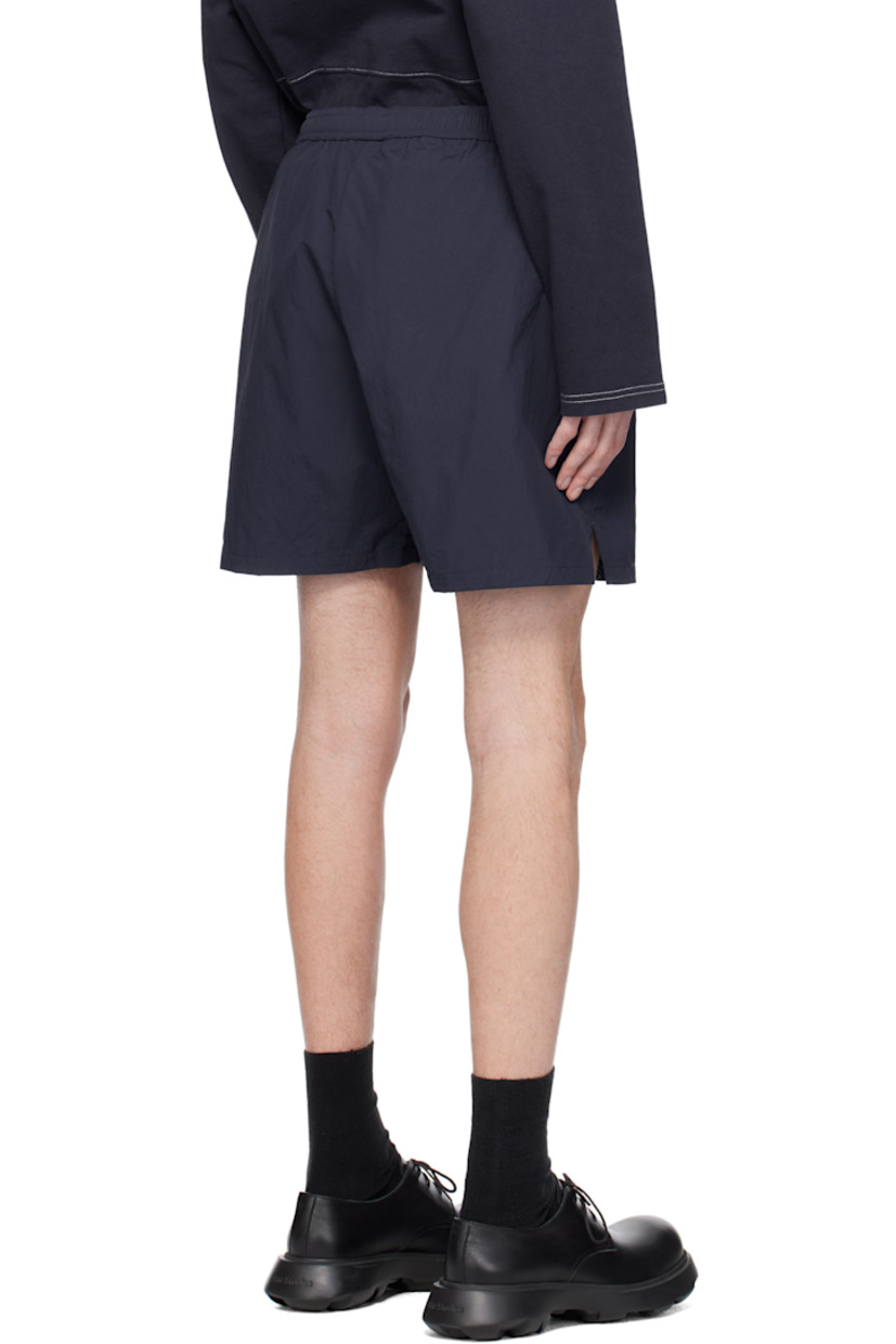 Polyester taffeta shorts.

· Concealed drawstring at elasticized waistband
· Two-pocket styling 
· Logo embroidered at leg
· Vented cuffs

Supplier color: Dark blue